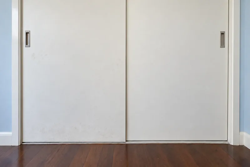 Sliding wardrobe doors with smudges on the left door, the right door clean – domestic cleaning in Gungahlin