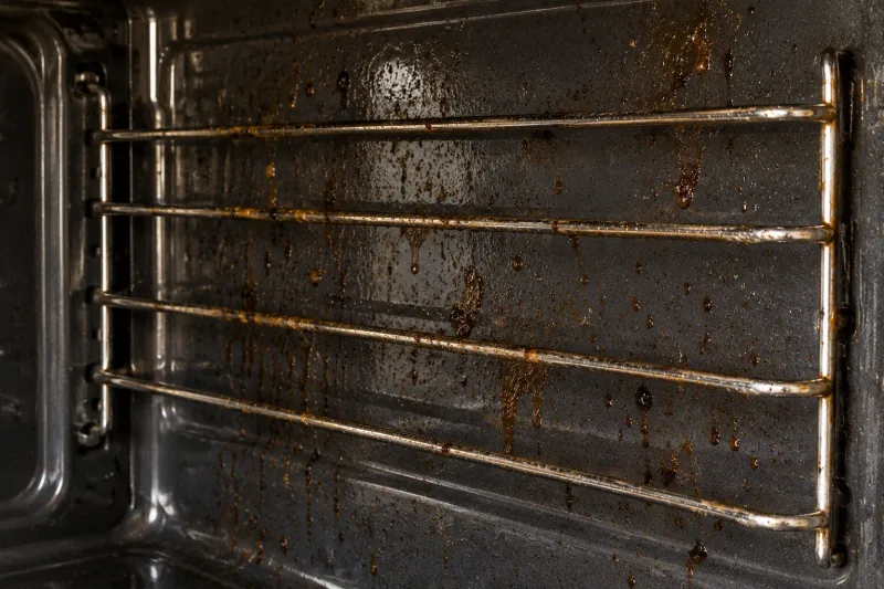 Oven side rack runners and wall streaked with dripping brown grease – oven cleaning in Geelong City